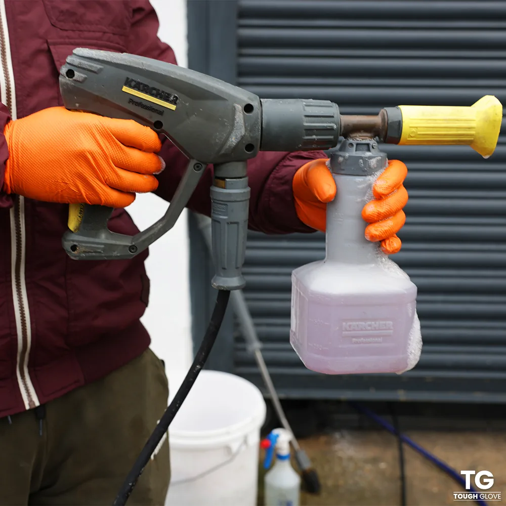 Gator Gripz gloves holding a pressure washer foam lance